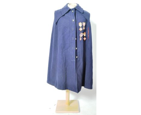 A post-WWII Second World War c1950s British nurses' uniform cloak / cape in black, with a selection of original enamel Red Cr