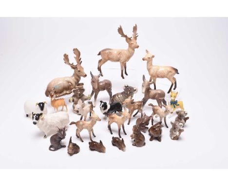 A collection of Beswick models of animals, comprising two sheep and a dog, two mice, a donkey, a family of five rabbits, a co