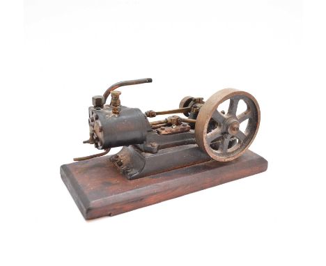 A horizontal mill steam engine fitted with a flywheel, the engine on a metal base further mounted on a wooden base board.25cm