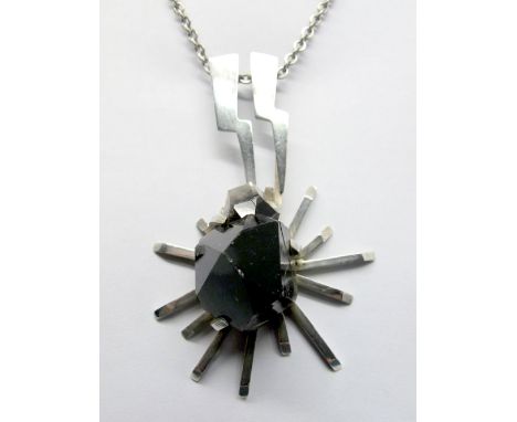 A Hallmarked Silver Pendant, FRN (Nunn), Sheffield 1978, of modernist design, set with quartz specimen, on long chain.