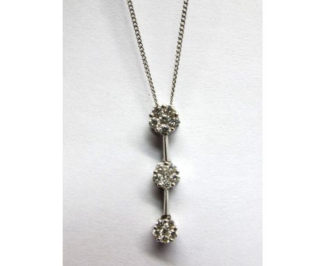 An 18ct White Gold Triple Cluster Drop Pendant, of uniform design, claw set on knife edge bars, on fine chain. *Ernest Jones 