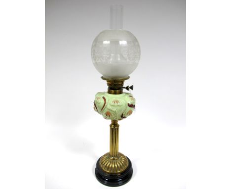 A Late XIX Century Oil Lamp, the brass fluted column with domed base, opaque pale green glass moulded and painted reservoir d