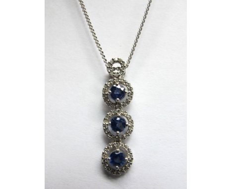 A 9ct White Gold Sapphire and Diamond Set Triple Cluster Drop Pendant, composed of three uniform circular clusters, below cir