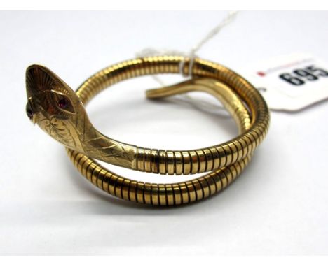 A 9ct Gold Serpent Bangle, (steel spring) with textured head and inset eyes. 