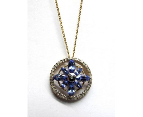 A Tanzanite and Diamond Openwork Pendant, claw set to the centre, of flowerhead design, within diamond set border, stamped "9