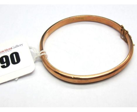A Chester Hallmarked 9ct Gold Bangle, of plain design, hinged to snap clasp. 