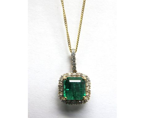 An 18ct Gold Zambian Emerald and Diamond Cluster Pendant, square four claw set to the centre, within border of brilliant cut 