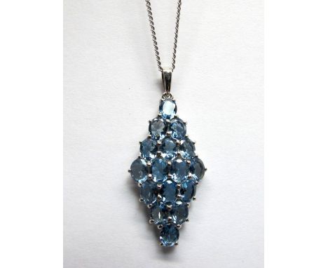 A 9ct White Gold Aquamarine Set Pendant, of elongated tapering design, oval claw set throughout, on 9ct white gold chain.  *E