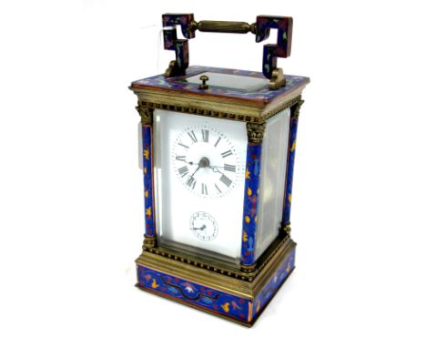 An Early XX Century French Carriage Clock, with brass and champlevé enamel case, the blue ground decorated with scrolling flo