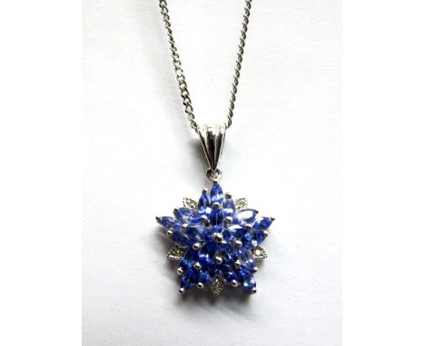 A Tanzanite and Diamond Set Cluster Pendant, of flowerhead design, navette shape claw set throughout, stamped "14k", on 9ct w