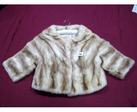 A Cream Shaded Mink Cocktail Jacket, with three-quarter length sleeves and three gilt button fastenings.