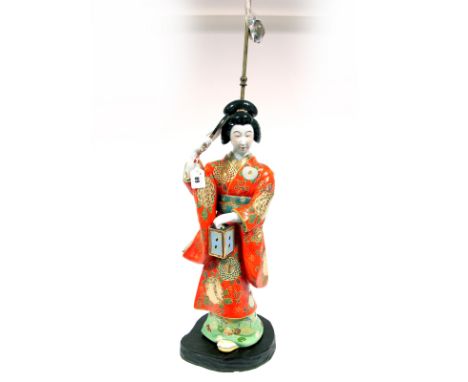 A Mid XX Century Japanese Porcelain Table Lamp, modelled as a Geisha holding a lantern and a fan, wearing a brightly coloured