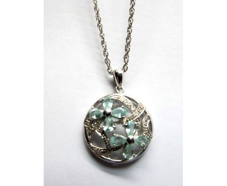 A Blue Tourmaline and Diamond Set Openwork Pendant, of circular design claw set, stamped "750", on 9ct white gold chain. *Ern