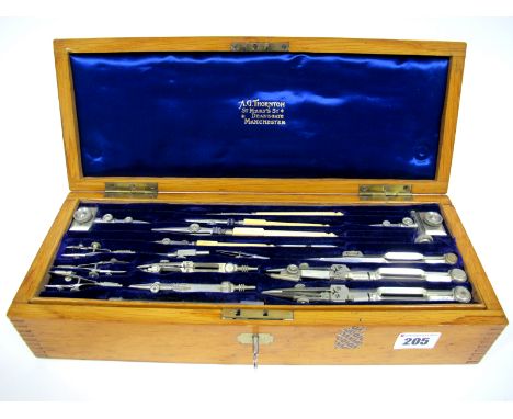 An Early XX Century Geometry Set, by A.G Thornton, Manchester, contained in an oak box, with lift-out tray fitted with instru