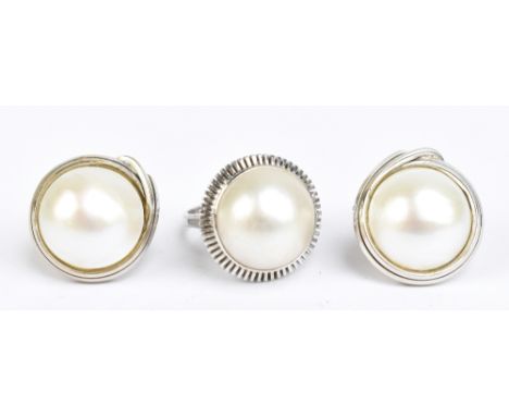 A suite of 14ct white gold and Mabé pearl jewellery comprising a ring, size M 1/2, and a pair of ear clips, each piece marked