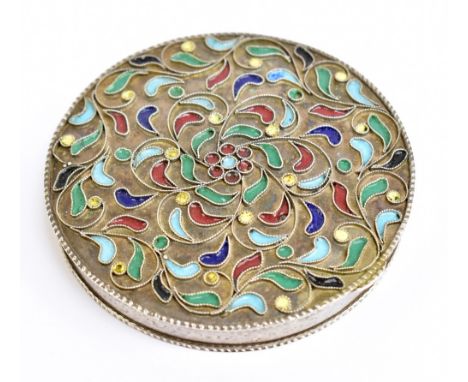 A Continental white metal and enamel compact of circular form with floral detail, the hinged cover enclosing a mirrored panel