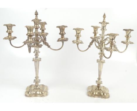 A pair of Elizabeth II hallmarked silver four branch candelabra, each raised central section above four reeded scrolling arms