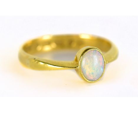 A 22ct yellow gold ring set with oval cut opal, size Q, approx 4.1g.Additional InformationWear commensurate with age and use.