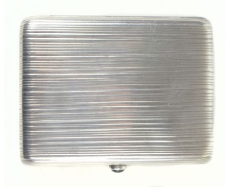 PYETR LOSKUTOV; a Russian silver cigarette case of rectangular form, with cast linear detail and applied green stone, with im