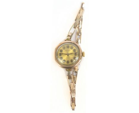 ROLEX; a lady's vintage 9ct yellow gold wristwatch, the circular enamel dial set with Arabic numerals and with fifteen jewel 