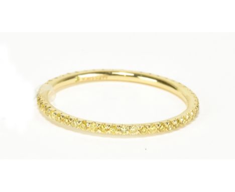 MESSIKA OF PARIS; an 18ct yellow gold and fancy yellow diamond full eternity ring, size N 1/2, approx 1g.