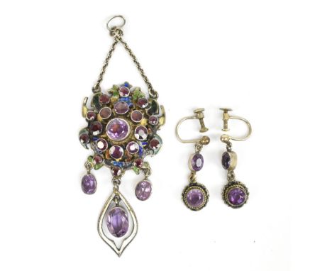 An unusual white metal enamel decorated and amethyst set pendant with both front and reverse enamelling and pierced drop, wit