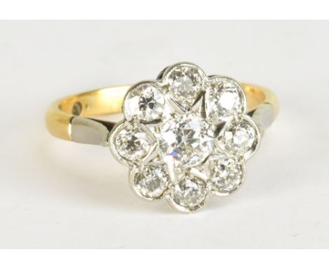 An 18ct yellow gold and white metal set diamond daisy cluster ring, the central stone weighing approx 0.50cts, size P1/2, app