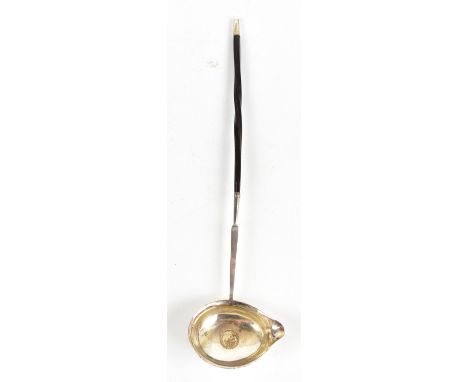 An 18th century white metal toddy ladle with turned whale bone handle, with inset William III &amp; Mary 1689 half crown, len