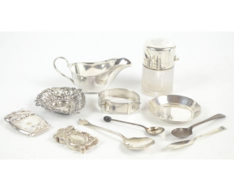 A group of small silver items including sauce boat, heart-shaped pin dish, small dish, hinged bangle in the form of a belt, c