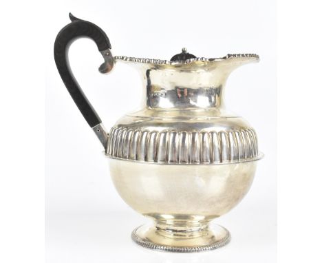 An Edward VII hallmarked silver footed water pot with gadrooned decoration to the central body, with a cast rim decorated wit