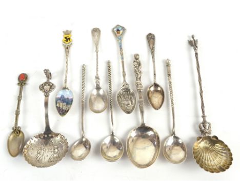 A collection of silver and white metal spoons including three Russian examples, each with chased detail to the reverse of the