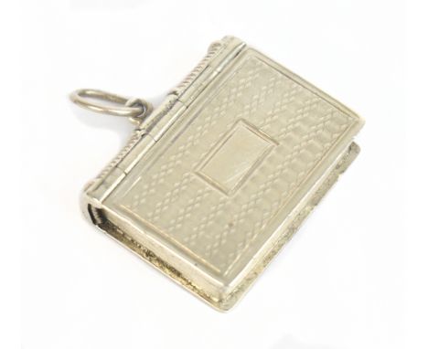 TAYLOR &amp; PERRY; a Victorian hallmarked silver vinaigrette in the form of a book with a cast edge and engine turned detail