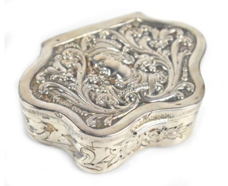 A late 19th century French hallmarked silver shaped trinket box embossed with the profile portrait of a young woman within sc