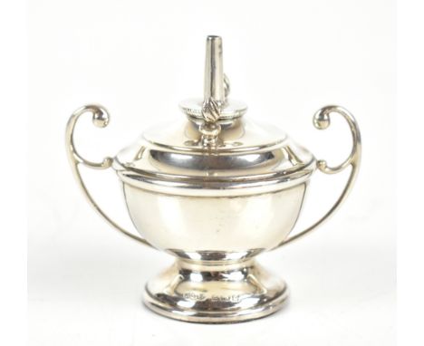 JOSEPH GLOSTER LTD; a George V hallmarked silver loaded table lighter in the form of a twin handled urn, with two tools and c