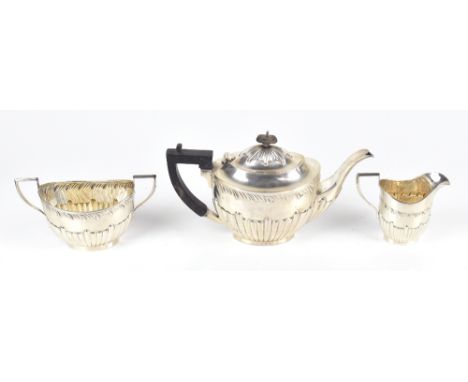 CHARLES HORNER (PROBABLY); an Edward VII hallmarked silver three piece tea service, with gadrooned decoration, Birmingham 190