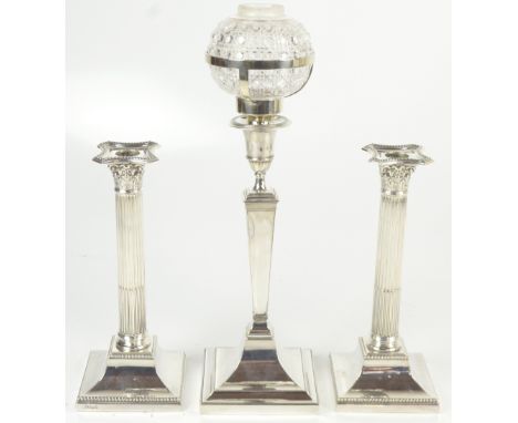 HAWKSWORTH, EYRE &amp; CO LTD; a pair of George V hallmarked silver Corinthian column candlesticks on loaded bases, height 27