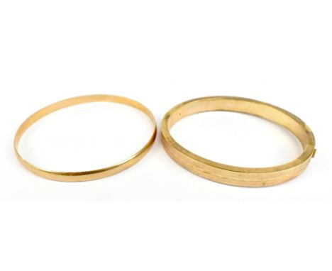 A 9ct yellow gold textured hinged snap bangle, internal width 6.2cm, and a simple 9ct gold bangle, approx 33.5g (2).Additiona