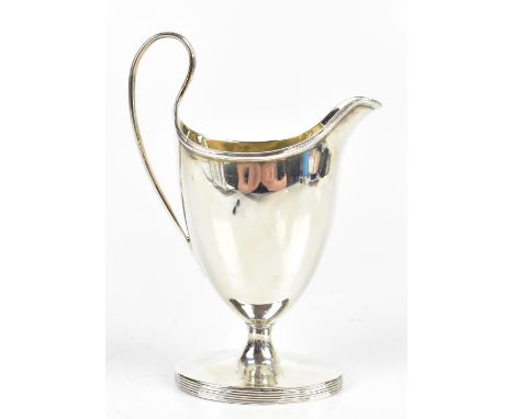 JOHN DOUGLAS; a George III hallmarked silver cream jug with cast liner rims, London 1810, height 16cm, approx 5.5ozt/171g.Add