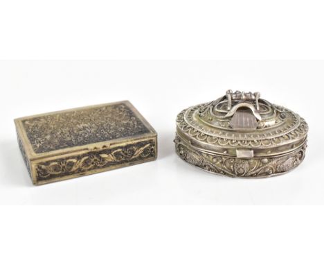 An Indian white metal snuff box of oval form with cast and filigree applied decoration, unmarked, length 5.5cm, and a further