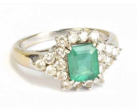 An 18ct white gold diamond and green stone dress ring, size R 1/2, approx 6.2g.Additional InformationThe central green stone 