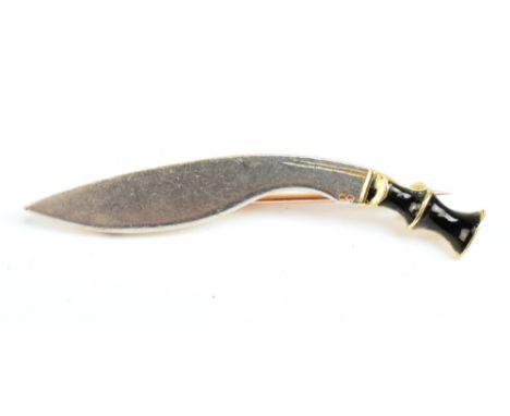 An 18ct yellow gold silver and black enamelled brooch in the form of a Gurkha's kukri knife, length 4.7cm, approx 6.3g.Additi