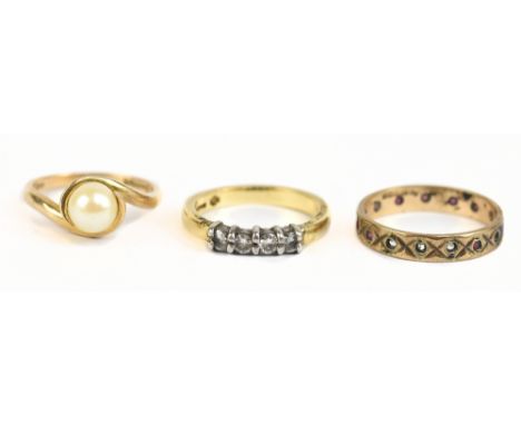 An 18ct yellow gold four stone ring, size L, approx 4g, a 9ct yellow gold eternity ring, size N 1/2, approx 1.8g, and a 9ct c