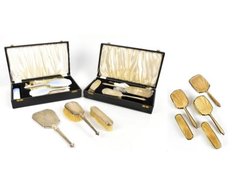 ARTHUR COOK; a hallmarked silver and guilloche enamelled five piece dressing table set, comprising hand mirror, two hair brus