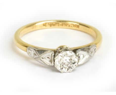 An 18ct yellow gold and platinum tipped diamond solitaire ring, the tiny diamond weighing approx 0.05cts, size M, approx 2.8g