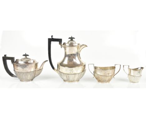 GF WESTWOOD &amp; SONS; a George V hallmarked silver three piece tea service with gadrooned lower body, Birmingham 1919-20, a