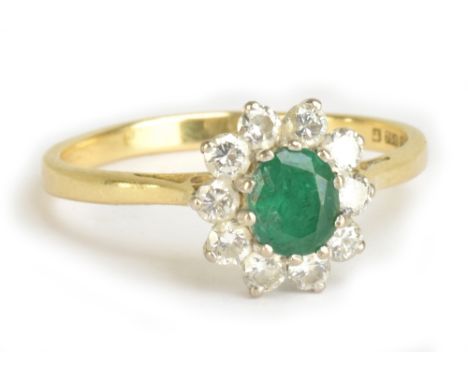 An 18ct yellow gold diamond and emerald cluster ring, size Q, approx 3.1g.Additional InformationUsual signs of wear with buil