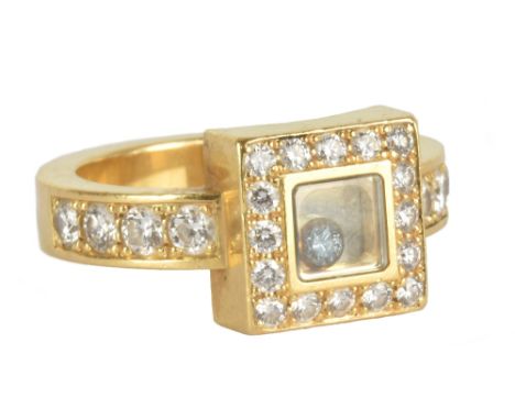 CHOPARD; a lady's 18ct yellow gold and diamond 'Happy Diamond' ring featuring single loose stone within glazed aperture set t