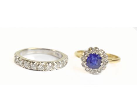 An 18ct yellow gold sapphire and diamond floral set ring, size O 1/2, and an 18ct white gold half eternity ring, size P, comb