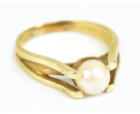 A yellow metal and pearl ring, the central pearl flanked by open claws, size N, approx 4.3g.