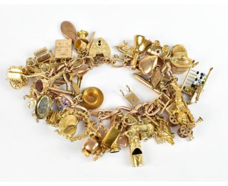 A 9ct yellow gold charm bracelet, set with multiple charms including abacus, kettle, letterbox, comb, train, whistle, etc, ap